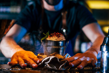 Close-up of bartender serving cocktail on bar counter in nightclub