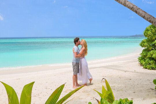 Happy couple kissing on the beach