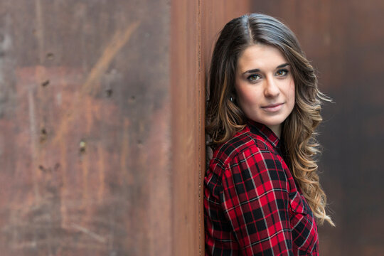 Portrait of young woman wearing red plaid shirt