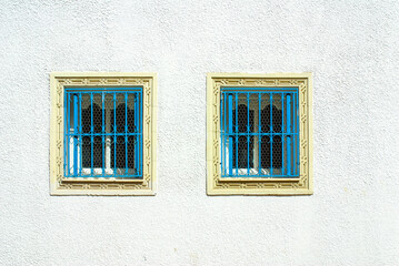 Fototapeta na wymiar Monastir, Tunisia, Africa - August, 2012: Traditional blue windows in Monastir town
