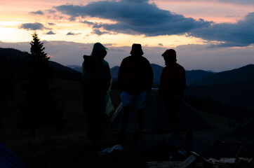 Tourists in the mountains. Man on the background of mountains. Sunset. Hike.