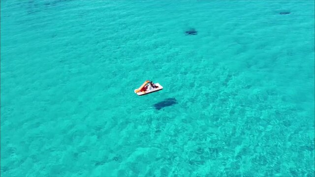 Pedal boat floating in the sea of Stintino, Sardinia, Italy