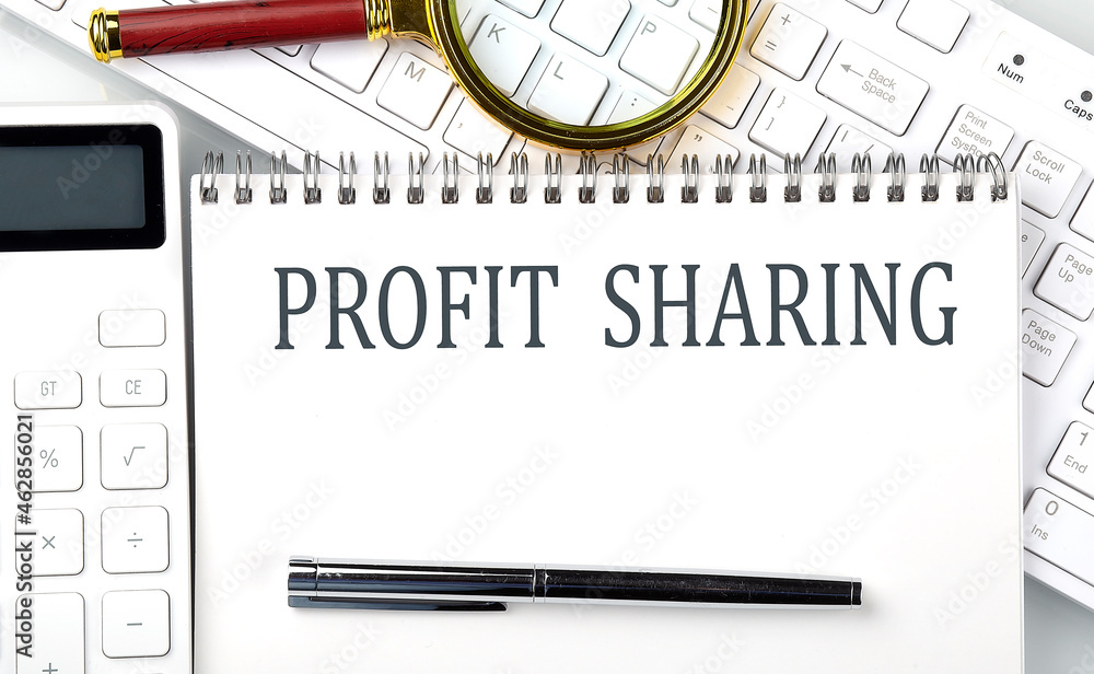 Poster profit sharing text on notepad with calculator and keyboard,business concept