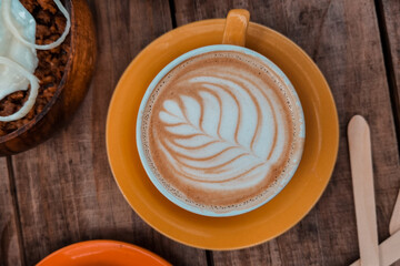 Delicious cup of coffee with latte art in middle

