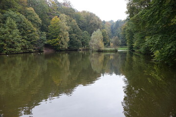 Fototapeta na wymiar Karlsbergweiher pond near the ruins of Schloß Karlsberg (Karlsberg Castle) on an autumn day, Homburg, Saarland, Germany 