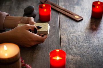 Fortune teller reading a future by tarot cards on rustic table	