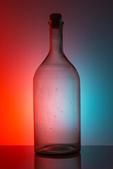 an old empty glass bottle on a black table