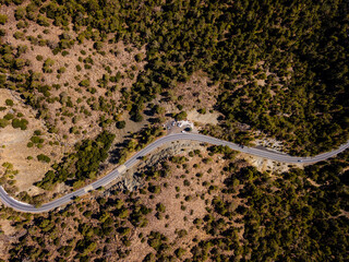 Top view from drone on hilly landscape with road