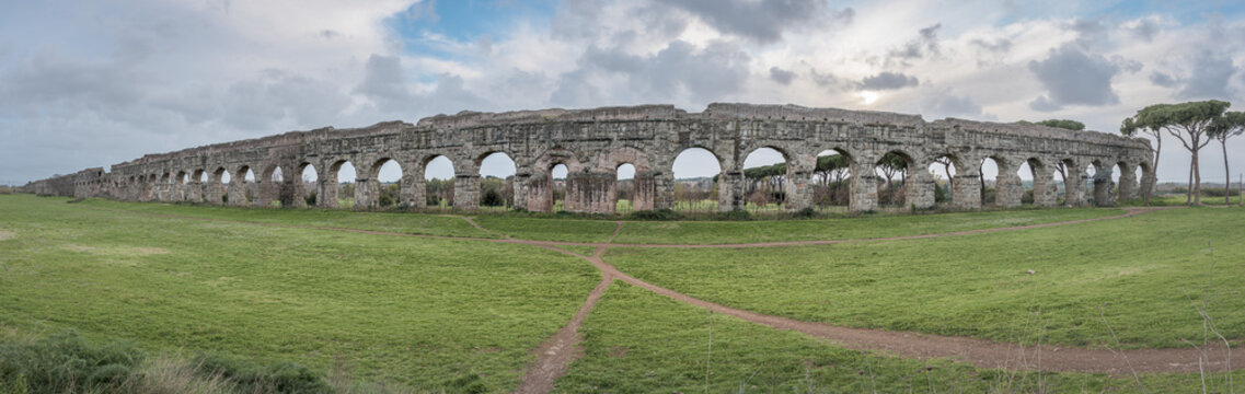 Ruins and arches of the Aqua Claudia  aqueduct, a waterbridge from the Roman Empire time bringing water to fountains, now in a public park Parco degli Acquedotti, Rome, Italy