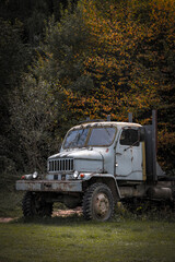 historical corroding truck in autumn nature