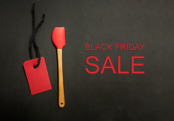 Spatula and price tag on black background. Black Friday Sale or Discount banner for bakery or kitchenware shop. Modern minimal design with space for text. Template for promotion, advertising, web