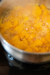Butternut squash pumpkin boiling in a pot