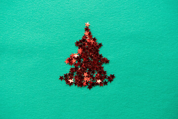 confetti stars are stacked in the shape of a Christmas tree. christmas composition