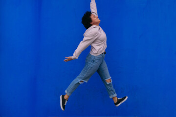 Fototapeta na wymiar Young Stylish Afro Woman Jumping