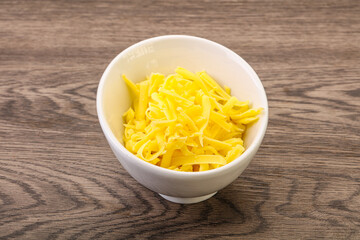 Shredded yellow cheese in the bowl
