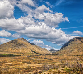 Scottish Highlands with deep valley against cloudy sky in Scotland