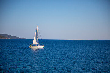 Obraz premium View of small yacht boat sailing in calm open sea in Montenegro 