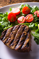 detail with grilled beef steak with tomatoes and salad