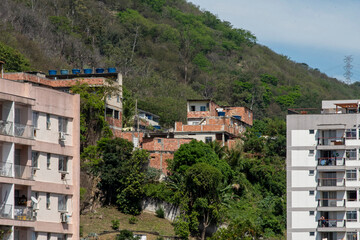 urban area with slums, simple buildings usually built on the hillsides of the city