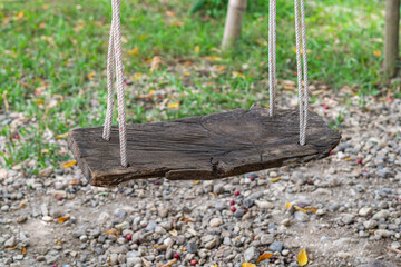 Empty old wooden swing in the park. Space for text. Activity and Relaxation concept