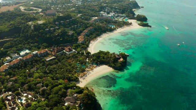 Tropical white sand beach, hotels near the blue lagoon and corall reef. aerial view, Boracay, Philippines. Seascape with beach on tropical island. Summer and travel vacation concept.