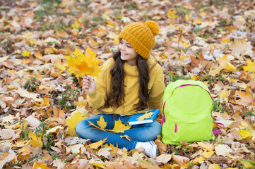 natural beauty. fall season fashion. teen girl in hat hold autumn leaf. smiling child having fun