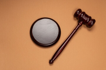 Gavel down on stand on brown background. Justice of law system conceptual.