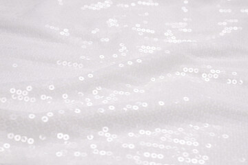 White sequin background. White shiny sequin fabric.