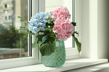 Bouquet with beautiful hortensia flowers on window sill