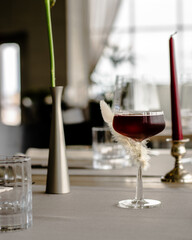 Red cocktail decorated with a feather at a restaurant