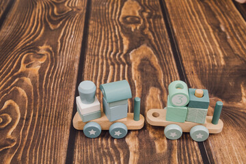 Wooden steam locomotive on wooden background. Educational toys for children. concept of eco materials in production Children's games.