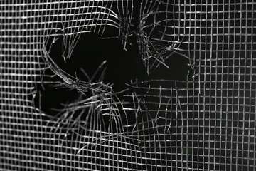 Torn window screen against black background, closeup - Powered by Adobe