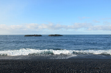 Waves Rolling Ashore of a Black Rock Beach in Iceland