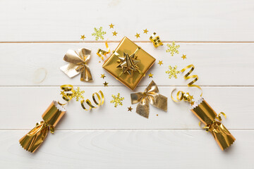 Christmas crackers with shiny confetti on color background, top view, copy space