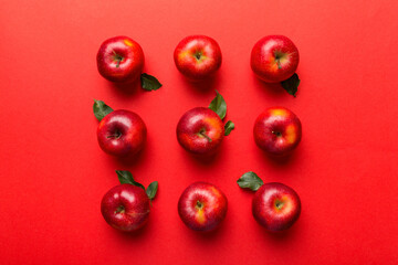 Many red apples on colored background, top view. Autumn pattern with fresh apple above view with copy space for design or text