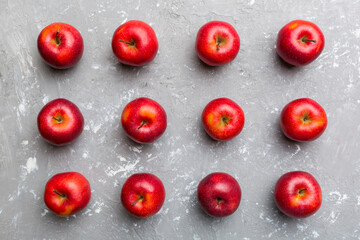 Many red apples on colored background, top view. Autumn pattern with fresh apple above view