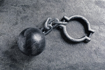 Prisoner ball with chain on grey table, top view