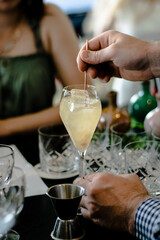 Beautiful yellow cocktail with an ice cube at a restaurant