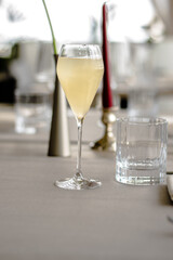 Beautiful yellow cocktail with an ice cube at a restaurant