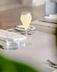Beautiful yellow cocktail with an ice cube at a restaurant