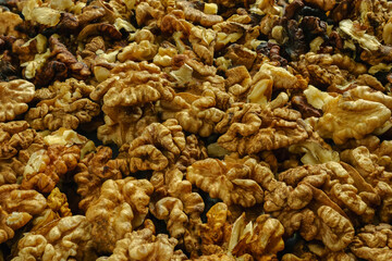 Lots of peeled walnuts in close-up. Selective focus. Background image.