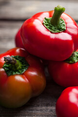 Fresh raw sweet red pepper on old wooden background. Pepper ratunda (gogoshar). Food background 