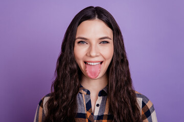 Closeup photo of funny attractive lady funny girlish stick tongue playful mood isolated violet...