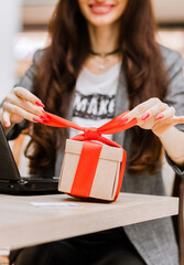 christmas, holidays, technology and shopping concept - smiling woman with credit card on the table,...