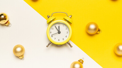New year clock 2022. Retro style yellow clock in happy Christmas midnight. Countdown to happy xmas on yellow background. Merry Christmas and Happy New Year.