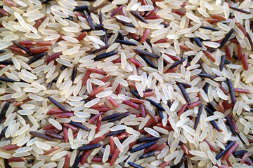 Close-up on a stack of three variaty of rices.
