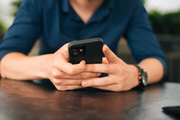 Close up photo of man hands using a smart phone.