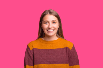 Fototapeta premium Photo of a cute blonde woman is smiling over pink background.