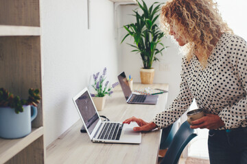Home workplace desktop and businesswoman using laptop computer to check notifications or send messages. Concept of smart working modern female people busy in online job store business