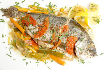 Grilled fish with tomato sauce and lemon slices